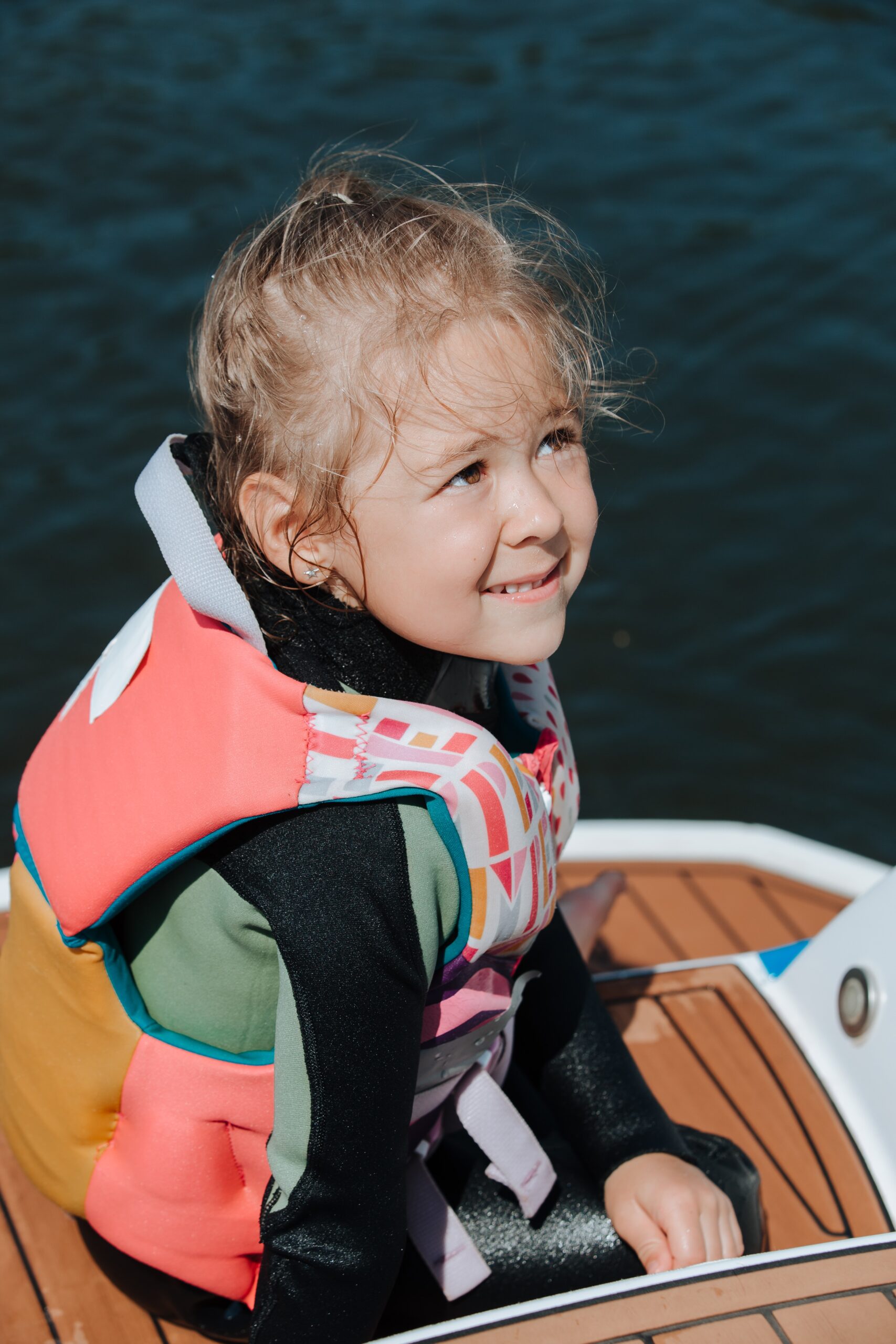 Young girl with a lifejacket, ready to go swimming.