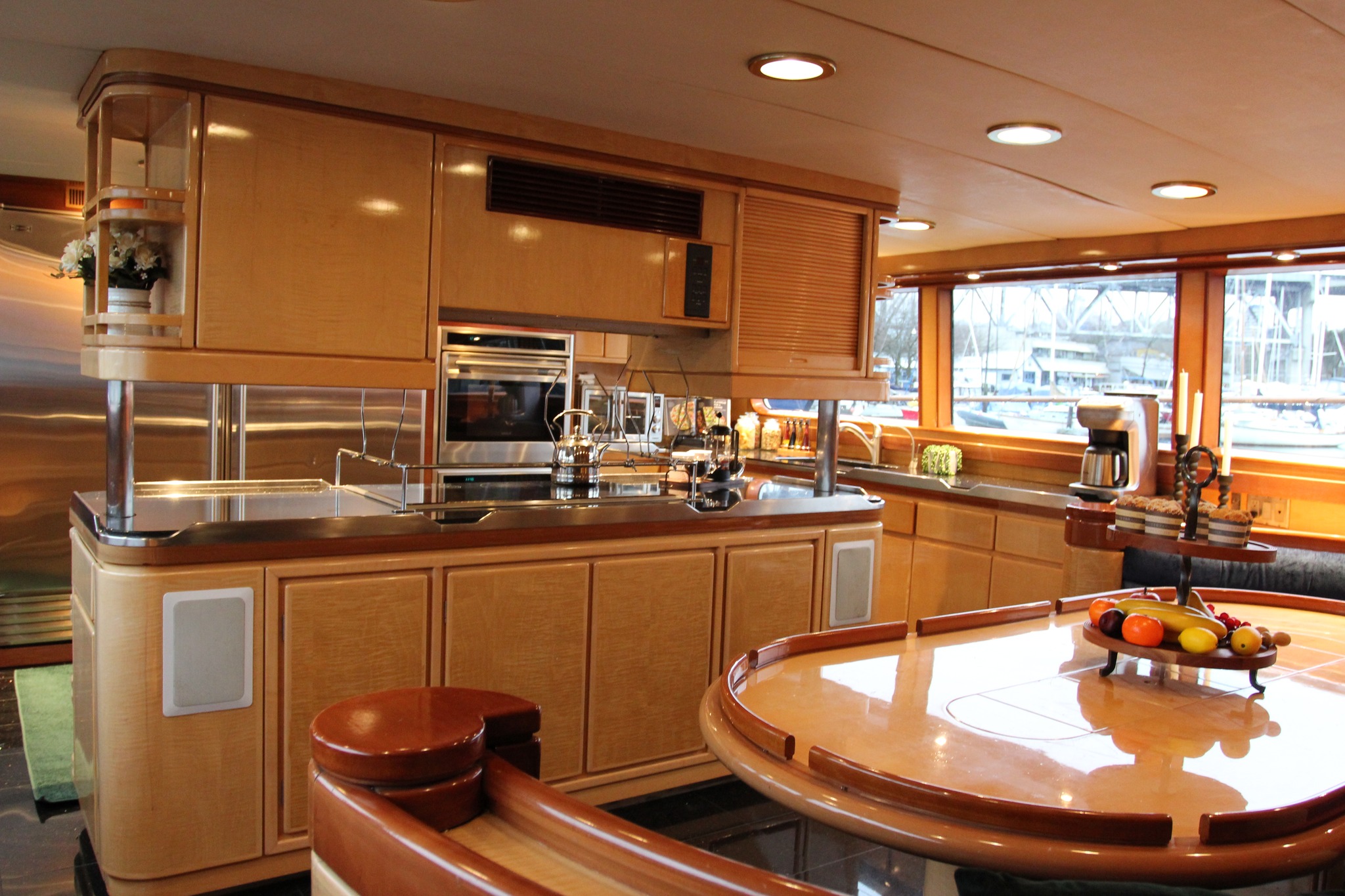 Large, state-of-the-art kitchen with and island and dining area on Vancouver's luxury superyacht, All of Me.